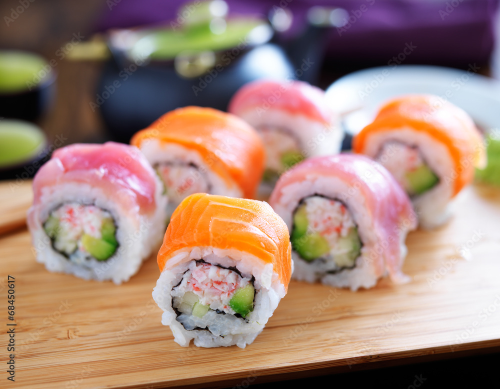 salmon and tuna sushi on a wooden tray salmon and tuna sushi on a wooden tray