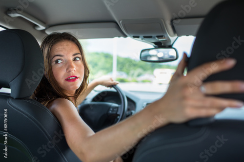 Young, woman driving a car, going home from work © lightpoet