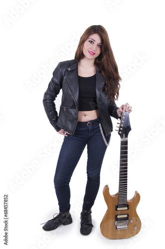 Beautiful rebel young girl posing with electric guitar