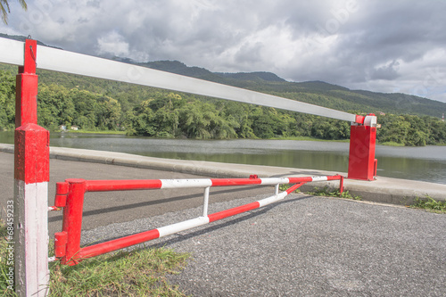 red Barrier Gate with mountain and lake background
