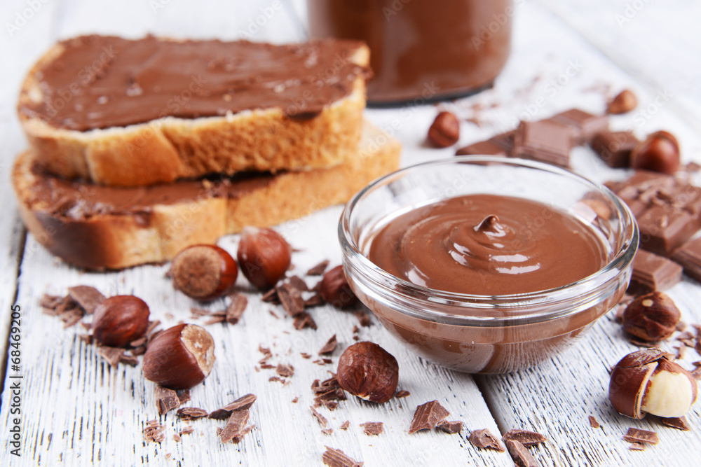 Sweet chocolate cream in bowl on table close-up