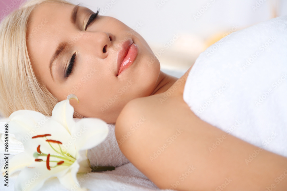 Beautiful young woman having relax in spa salon