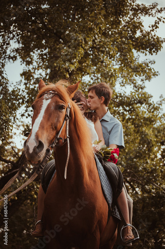Young beautiful couple  with a horse. Filtered. Selective focus. © ruslan1117