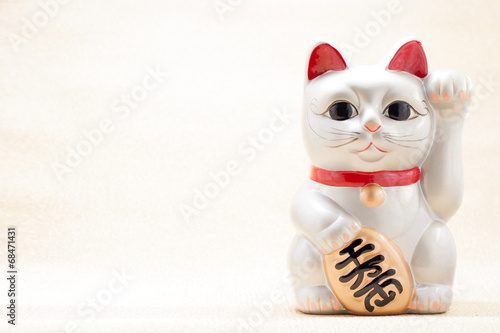 Japanese beckoning cat also known as maneki neko photo