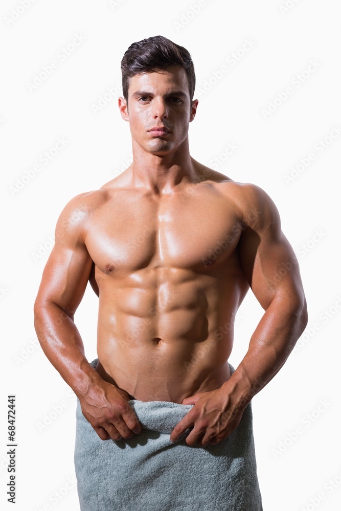 Portrait of a shirtless muscular man wrapped in white towel Portrait of a shirtless muscular man wrapped in white towel