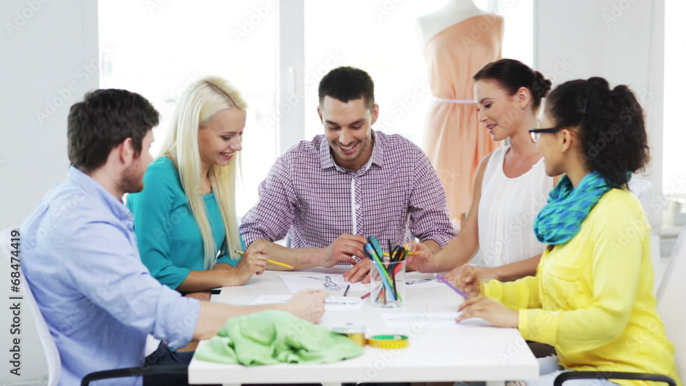 smiling fashion designers working in office smiling fashion designers working in office