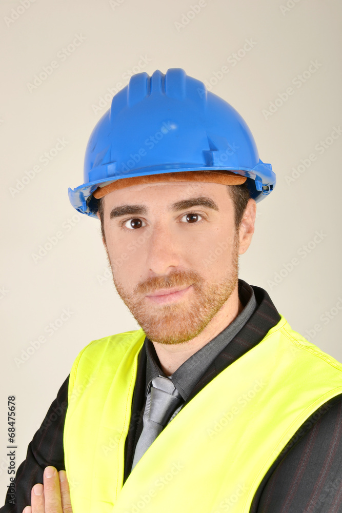 Businessman with construction helmet and reflective vest Businessman with construction helmet and reflective vest