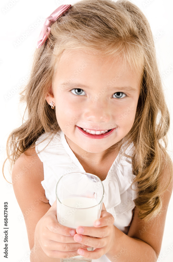 Smiling little girl drinking milk isolated on a white Smiling little girl drinking milk isolated on a white