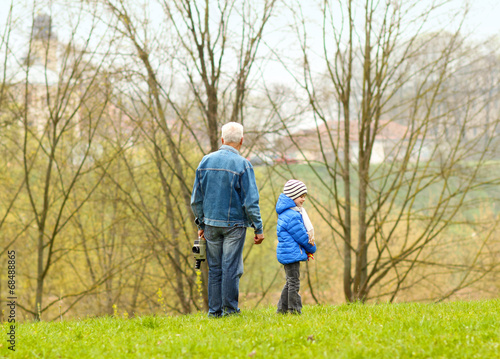 Grandfather helping his grandson to make a film