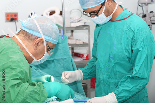 Student assistant helping doctor in a surgery