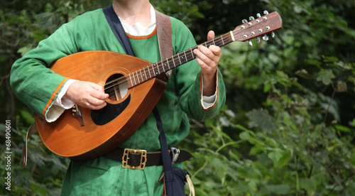 Картината върху платно A Musician Playing a Classic Medieval Mandolin.