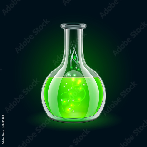 Transparent flask with magic green liquid on black background.