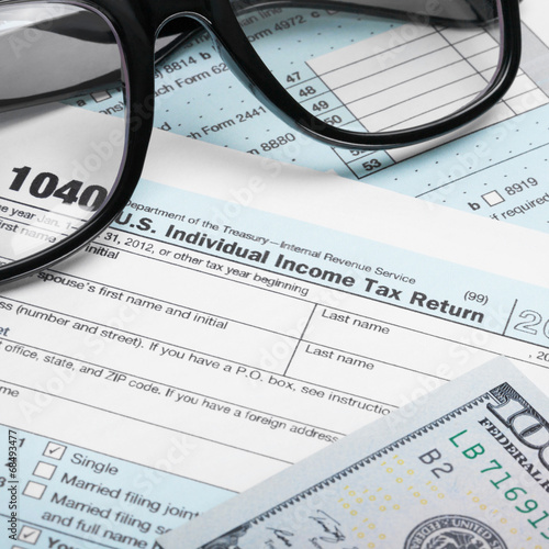 USA Tax Form 1040 with glasses and 100 US dollars - 1 to 1 ratio