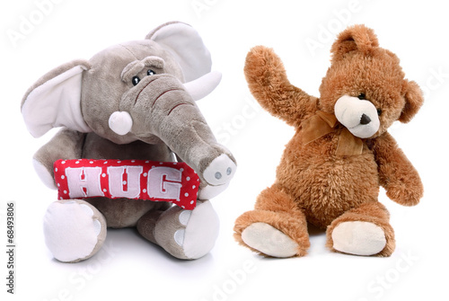 Sweet teddy bear and plush elephant on a white background