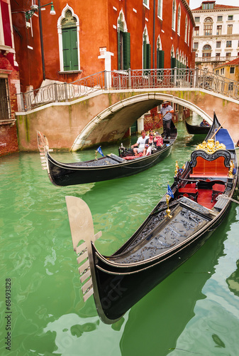 Romantic gondolas on canal in Venice, Italy #68493828