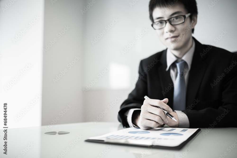 business report and man hand with pen business report and man hand with pen