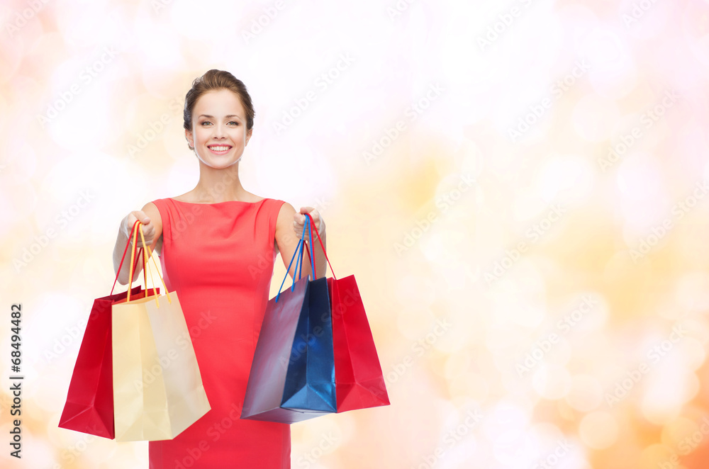 smiling elegant woman in dress with shopping bags smiling elegant woman in dress with shopping bags