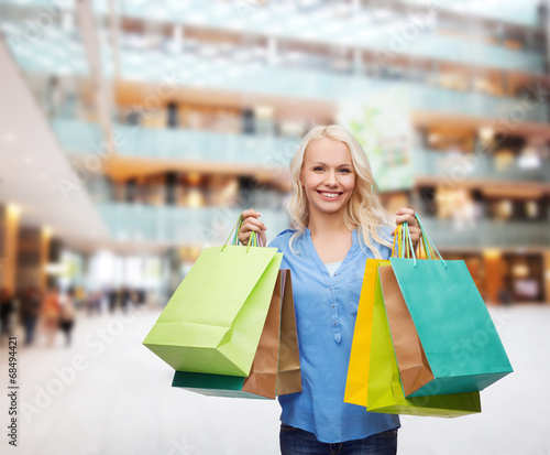 smiling woman with many shopping bags