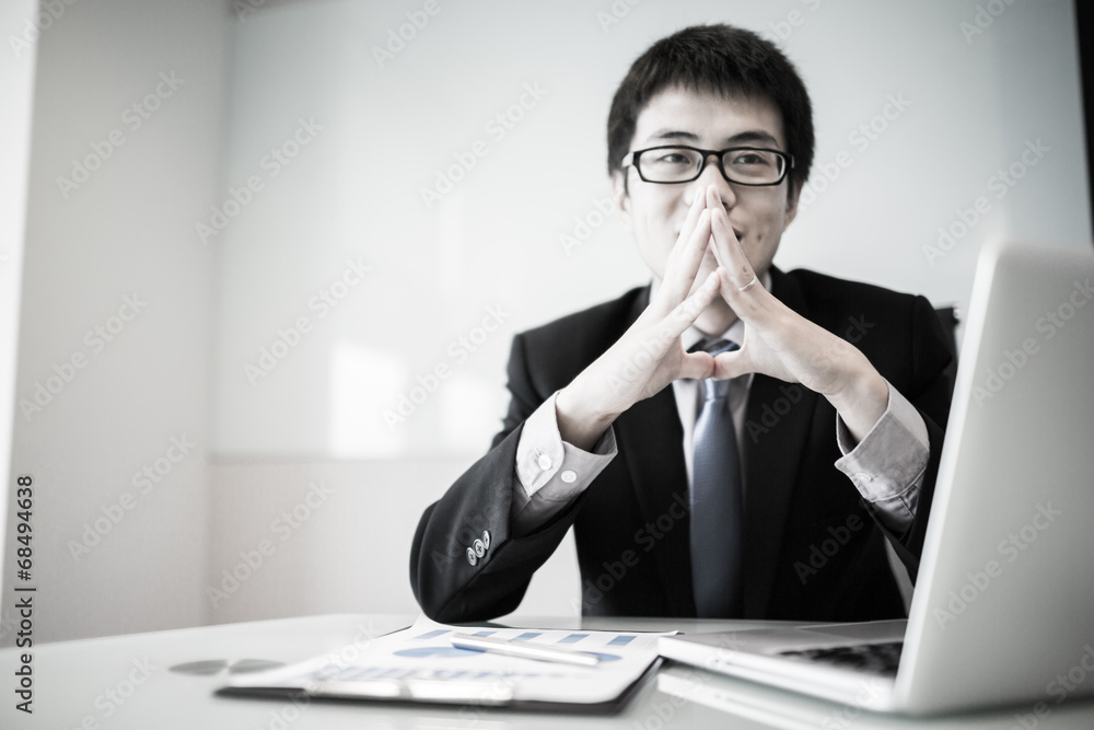 Young handsome man using laptop in his office Young handsome man using laptop in his office