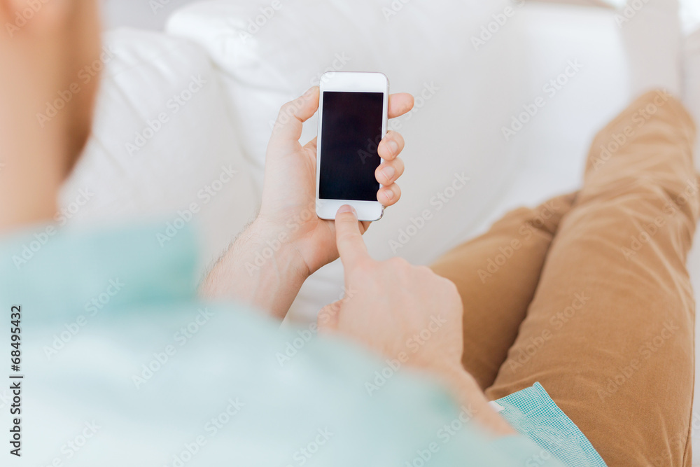 close up of man sitting with smartphone at home close up of man sitting with smartphone at home