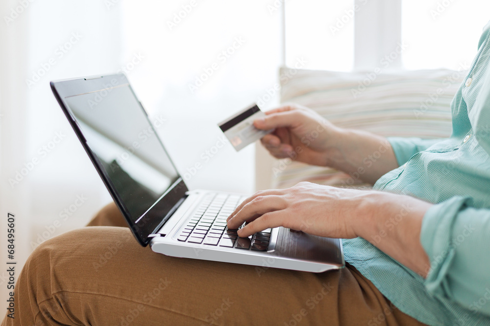 close up of man with laptop and credit card close up of man with laptop and credit card