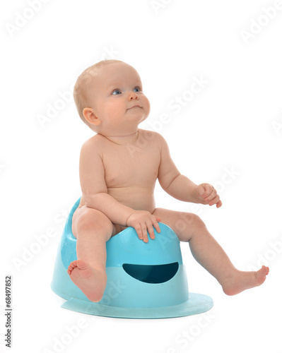 Infant child baby boy toddler sitting on potty toilet stool pot