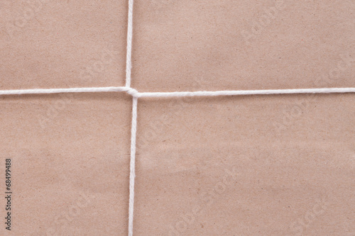 Background of white cardboard paper tied with twine