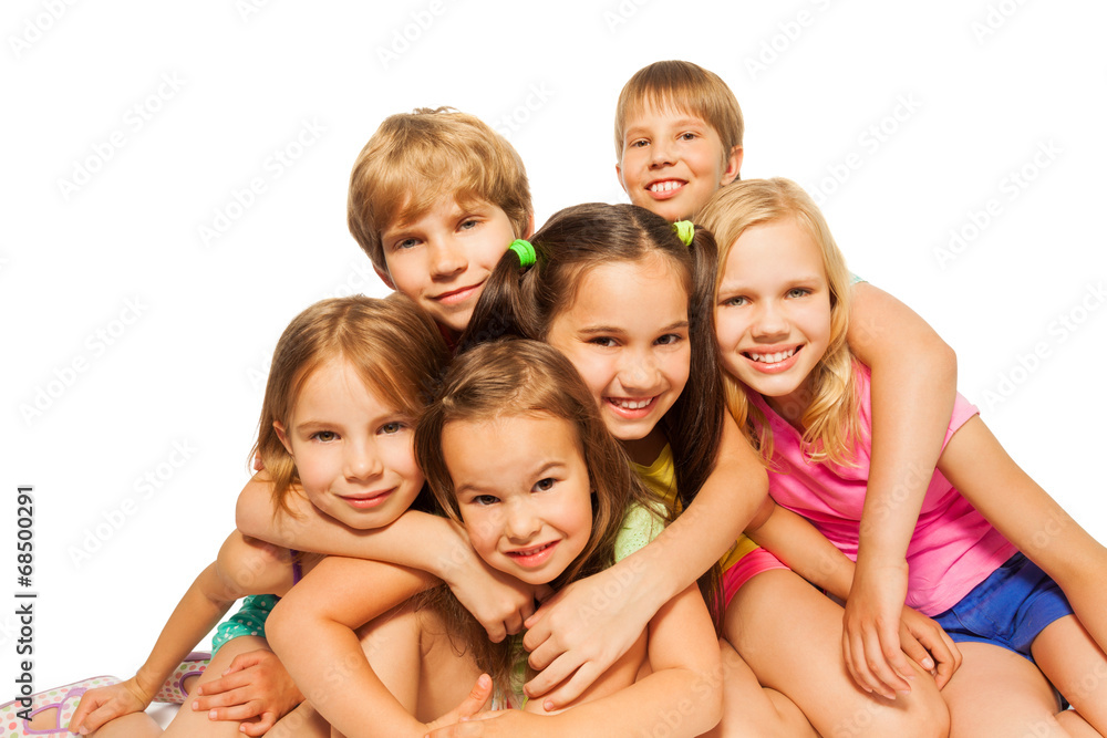 Six children sit hugging together