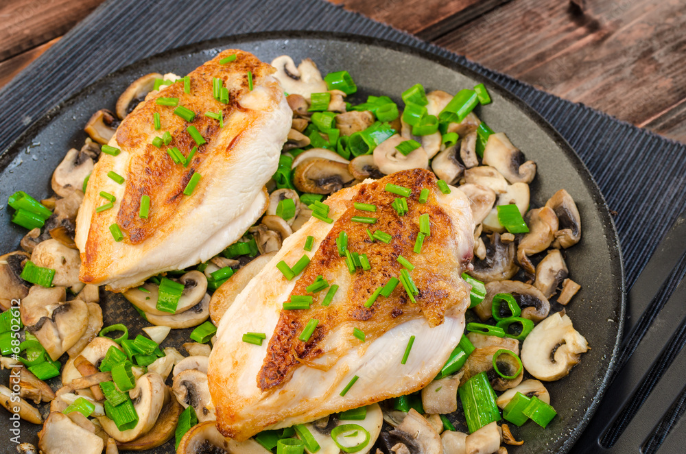 Chicken breast with mushrooms and spring onions on pan Chicken breast with mushrooms and spring onions on pan