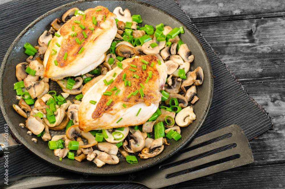 Chicken breast with mushrooms and spring onions on pan Chicken breast with mushrooms and spring onions on pan
