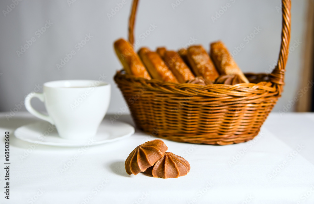 Basket with bread and sweet and tea