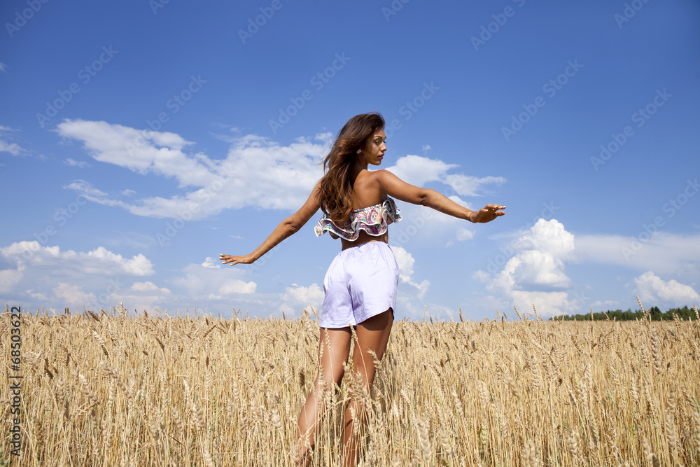 Young woman in a wheat golden field Young woman in a wheat golden field