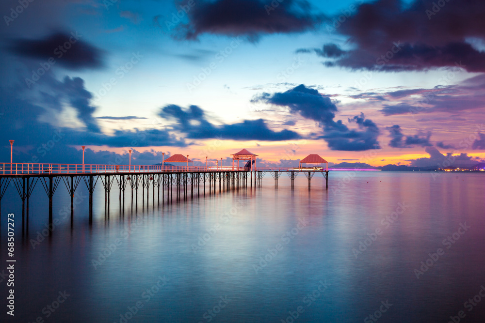 Sunset pier along coast