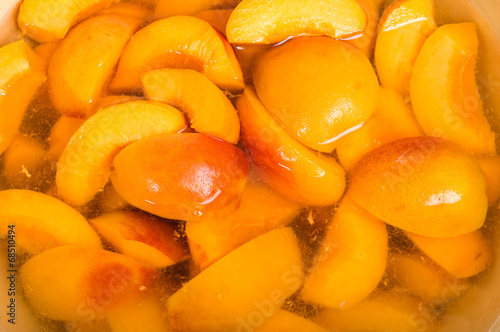 Bowl of fresh sliced peaches in syrup