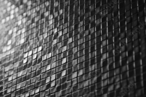 Dark tiles mosaic pattern on a wall