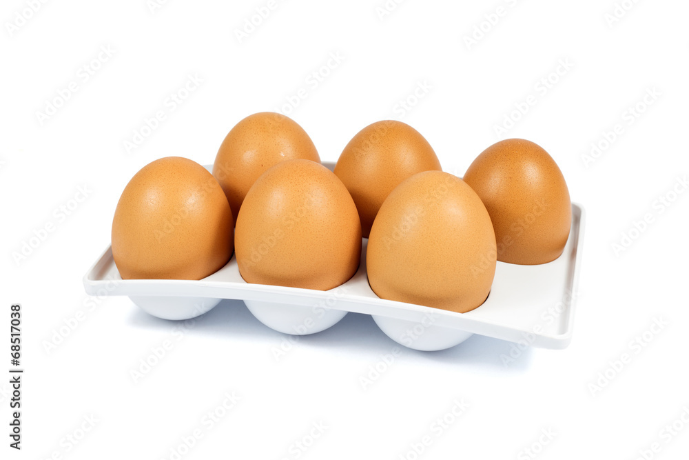 Six Brown Eggs in a White Plastic Package Isolated on White Six Brown Eggs in a White Plastic Package Isolated on White