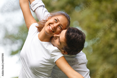Young Happy Couple Hugging and Laughing