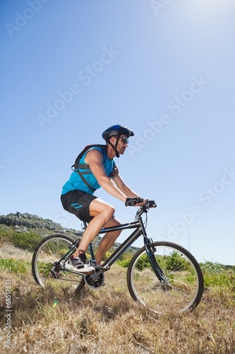 Fit cyclist riding in the countryside