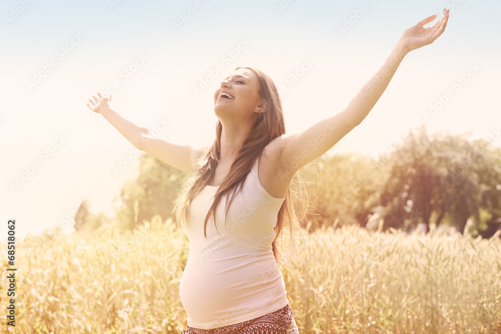 Pregnant woman enjoying the nature Pregnant woman enjoying the nature