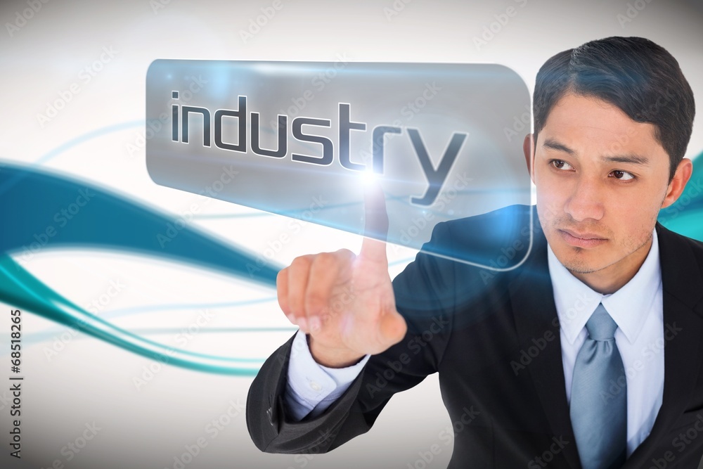 Businessman pointing to word industry Businessman pointing to word industry