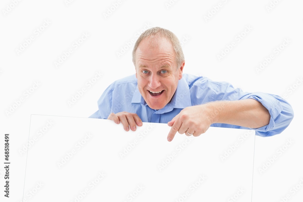 Mature man smiling at camera and pointing Mature man smiling at camera and pointing