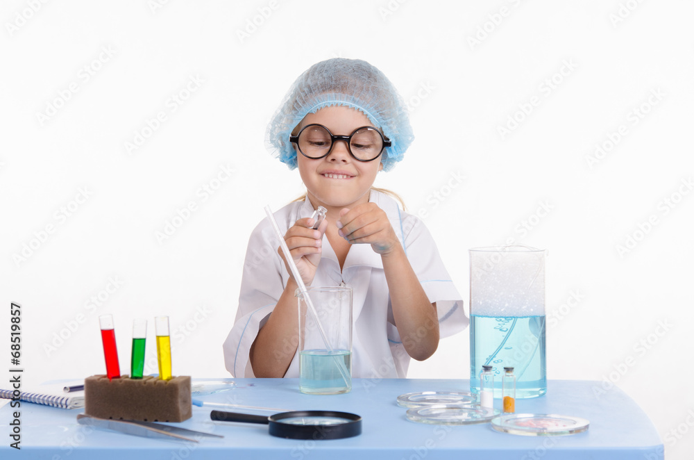 Child chemist opens the flask with reagent