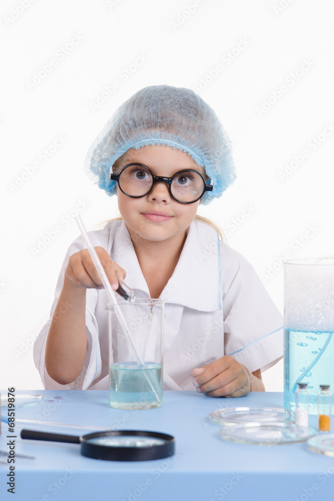 Chemist pours reagent liquid in the flask Chemist pours reagent liquid in the flask