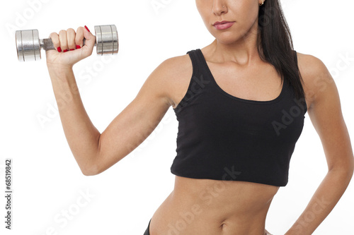 Body of slim female in activewear doing exercise with dumbbells
