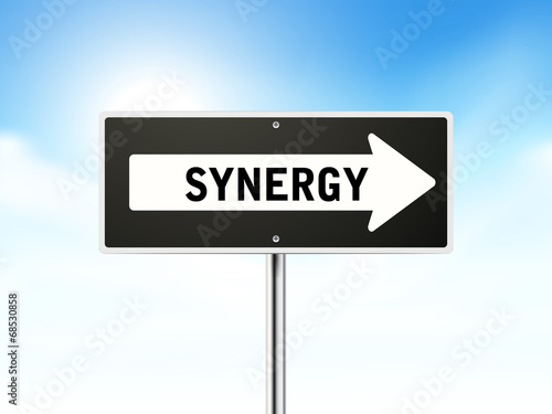 synergy on black road sign