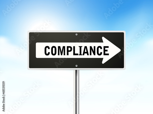 compliance on black road sign