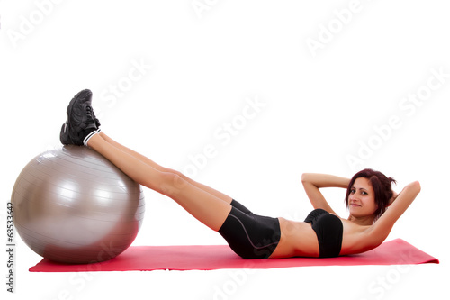 Beautiful healthy young girl with a fitness ball 