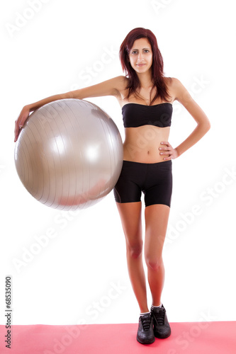 Beautiful healthy young girl with a fitness ball 