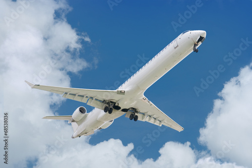big jet plane landing  blue cloudy sky background