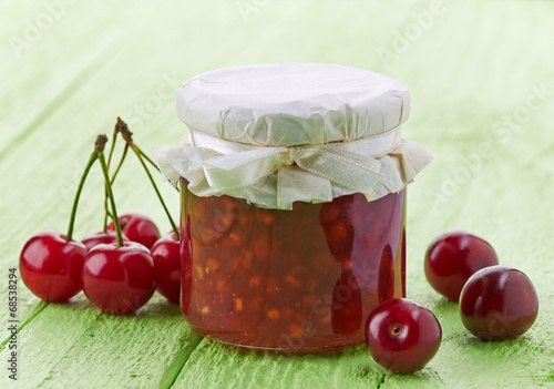 jar of cherry and apple jam photo